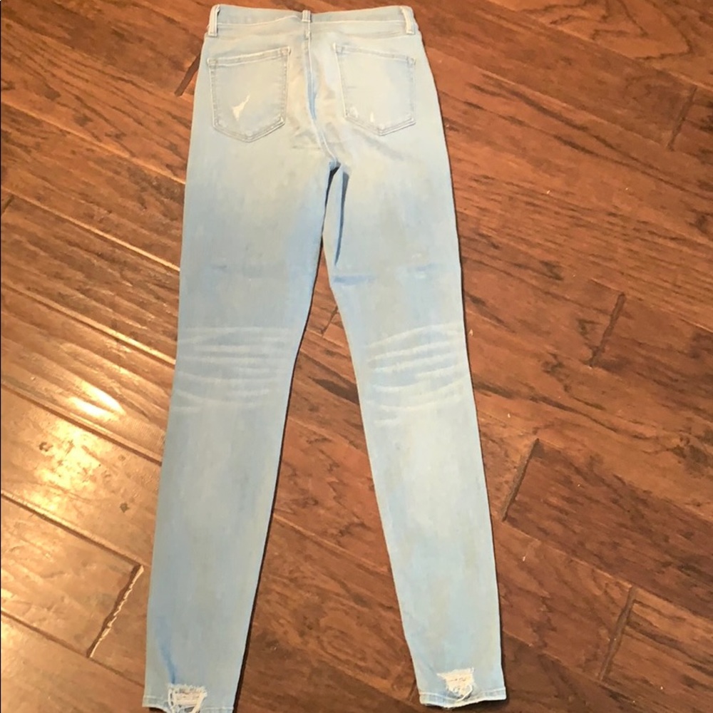 Barely worn light-denim skinny jeans with holes. - Picture 5 of 6